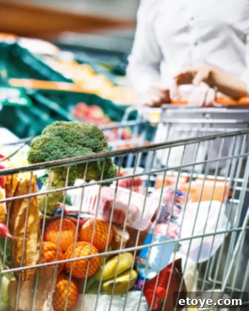 Woman with shopping cart, symbolizing budgeting for groceries and mindful shopping