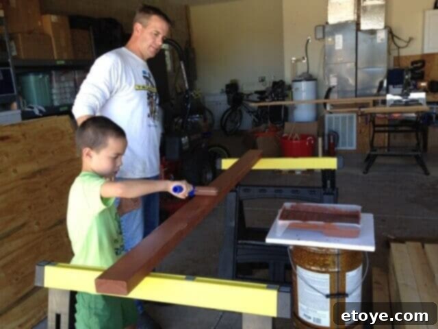 Chicken Coop Wood Staining Family members staining wood pieces for the chicken coop frame.