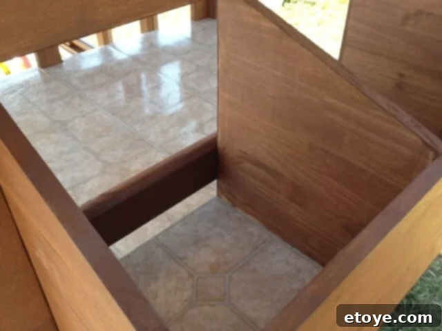 Chicken Coop Vinyl Flooring Vinyl flooring tiles installed on the sloped floor of the chicken coop.