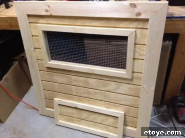 Main Coop Door Construction Completed and trimmed main access door for the chicken coop, ready for mounting.