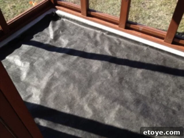 Chicken Coop Run Weed Block Weed block cloth laid on the gravel base of the chicken coop run floor.