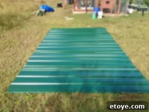 Metal Roof Panel Layout Metal roofing panels laid out on the grass for pre-measurement and trimming.