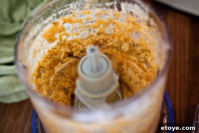 Fiery Kimchi Butter Steak 4 Ingredients for kimchi butter in a food processor, ready to be blended.