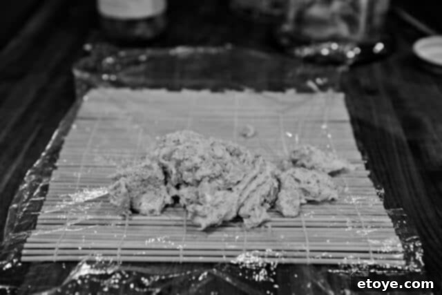 Fiery Kimchi Butter Steak 5 Spoonfuls of freshly made kimchi butter spread on plastic wrap, ready for rolling.