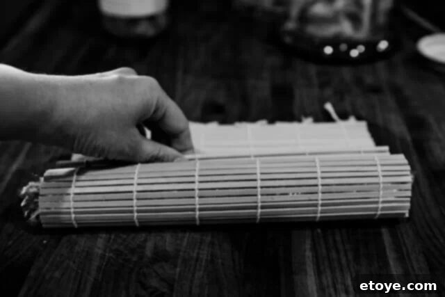 Fiery Kimchi Butter Steak 7 The sushi mat being used to roll the kimchi butter into a tighter log shape.