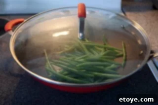 green-bean-mushrooms-stirfry-recipe-7136 Drained and crisp-tender green beans, ready for the stir-fry.