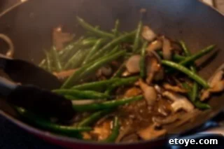 Savory Shiitake and Green Bean Stir-Fry 6 The finished Green Bean and Mushroom Stir-Fry, glistening with sauce.