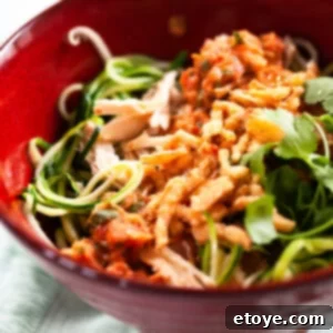 A close-up view of the Charred Tomato Salsa Chicken Bowl, showcasing the rich texture of the salsa, grilled chicken, and fresh garnishes.