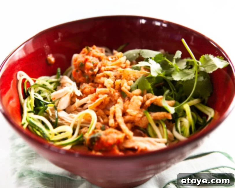 Fire-Kissed Tomato Salsa 5 A salad chicken bowl topped with vibrant charred tomato salsa, served in a striking red bowl.