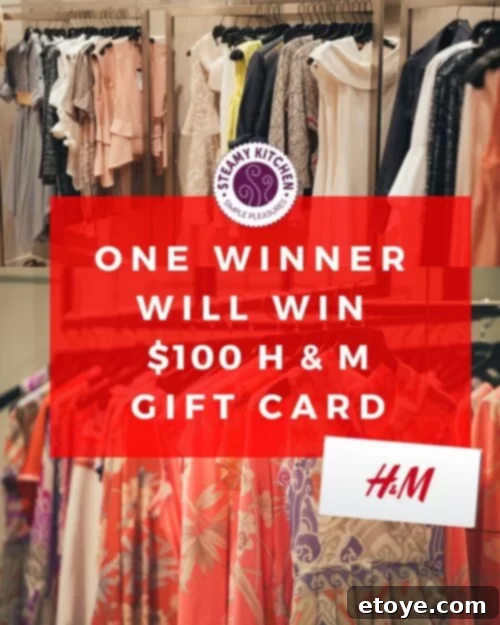 A person holding a $100 H&M gift card in a vibrant shopping environment