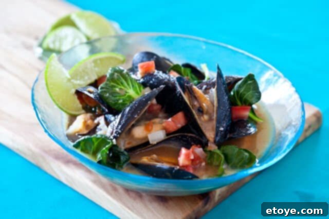 Spicy Miso Steamed Mussels 9 Cooked spicy mussels in miso broth served in a blue bowl