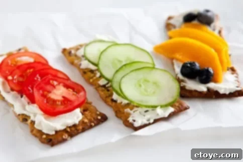 Lunchbox Love: Smart & Healthy School Lunches for Kids 3 A flat lay of crackers, cream cheese and options toppings like cucumber, tomato and fruit