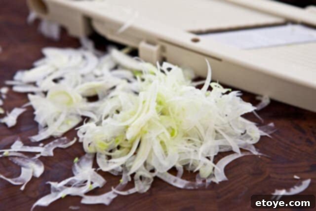 French Carrot Fennel Salad Recipe shaving fennel Shaving fennel bulb with a mandoline for a crisp and flavorful French Carrot Fennel Salad