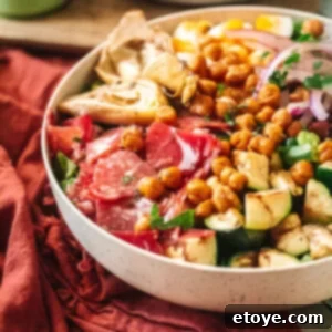 Classic Italian Chopped Salad 5 Italian Chopped Salad in a white bowl with red table cloth, close-up