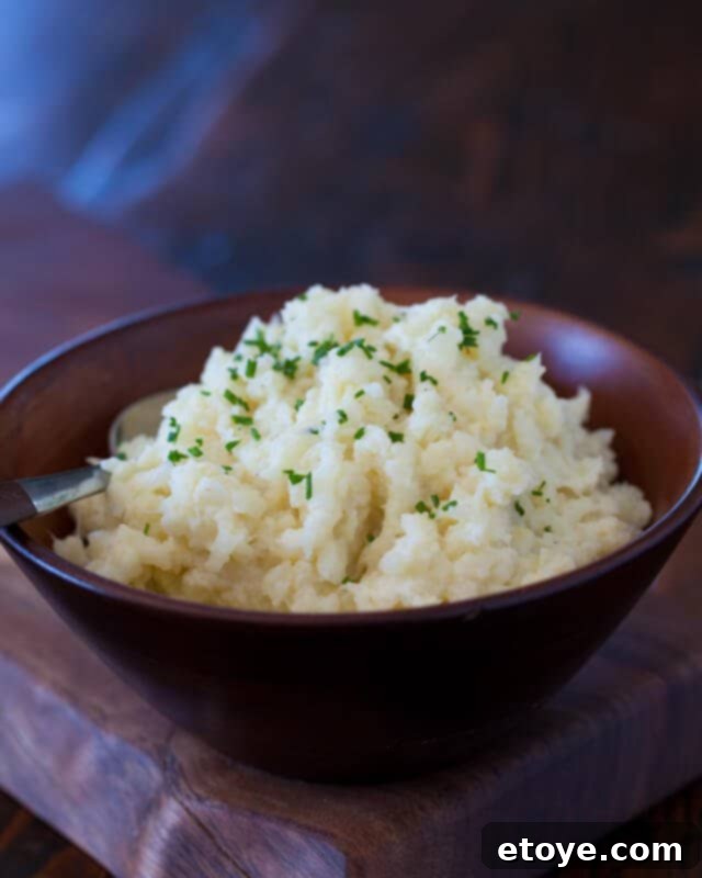 Cauliflower Mashed Potatoes Recipe: top with chives Cauliflower Mash Recipe in a bowl