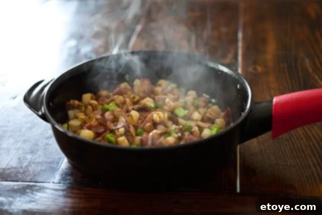 Finished Broccoli Potato Bacon Hash, garnished with fresh herbs, ready to be served.