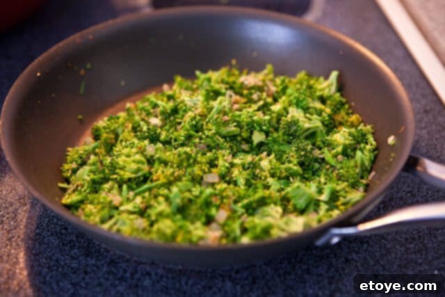 Flaky Broccoli Feta Spanakopita 2 Sautéing Onions, Garlic, and Broccoli for Spanakopita