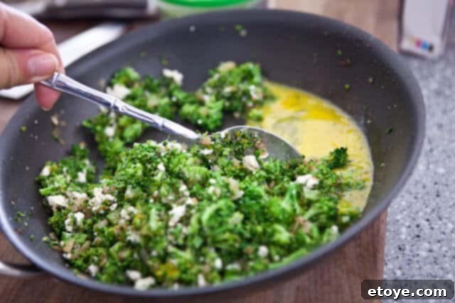 Flaky Broccoli Feta Spanakopita 3 Adding Egg to Broccoli and Feta Filling