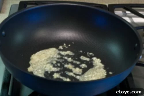 Add garlic and ginger to cold oil and wok