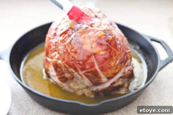 Sweet and Savory Easter Ham with Grilled Peaches 8 brushing ham with glaze