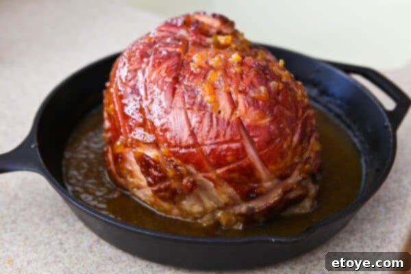 Sweet and Savory Easter Ham with Grilled Peaches 10 ham with peach juices in pan
