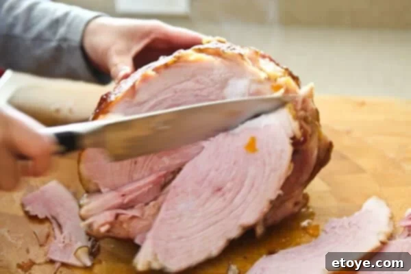 Sweet and Savory Easter Ham with Grilled Peaches 17 slicing off part of ham