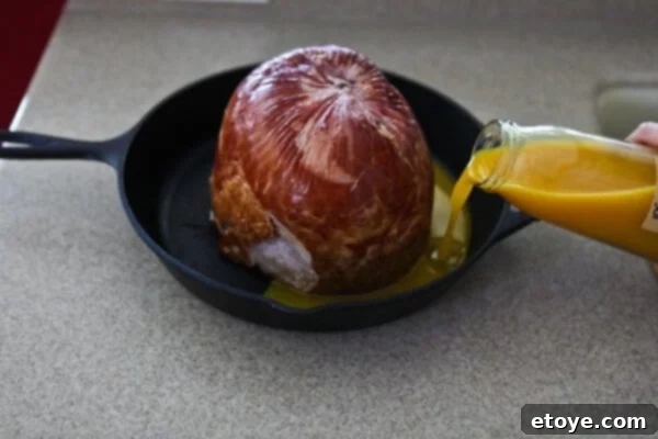 Sweet and Savory Easter Ham with Grilled Peaches 3 pouring juices onto ham