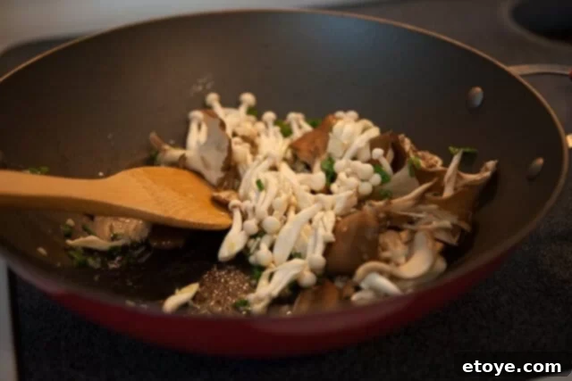 Miso Butter Garlic Noodles 3 Miso paste being stirred into the butter and mushroom mixture in a hot pan