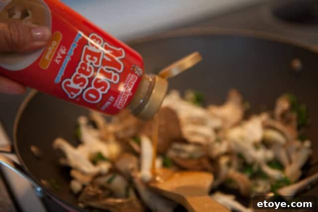 Miso Butter Garlic Noodles 4 Maggi or soy sauce being added to the miso butter and mushroom sauce