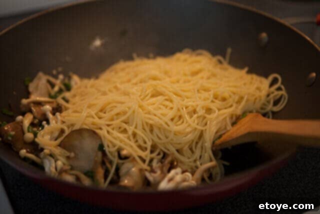 Miso Butter Garlic Noodles 6 Garlic noodles with miso butter being tossed vigorously in a pan for even coating