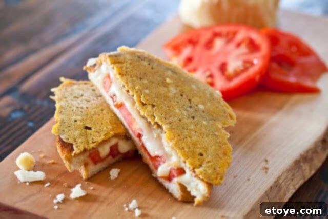 Super Frico Grilled Cheese Sandwich A glorious Super Frico Grilled Cheese sandwich, sliced in half, showcasing its gooey interior and spectacular crispy Parmesan exterior.