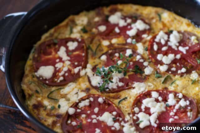 A beautifully golden-brown Zucchini Frittata, sliced and ready to be served
