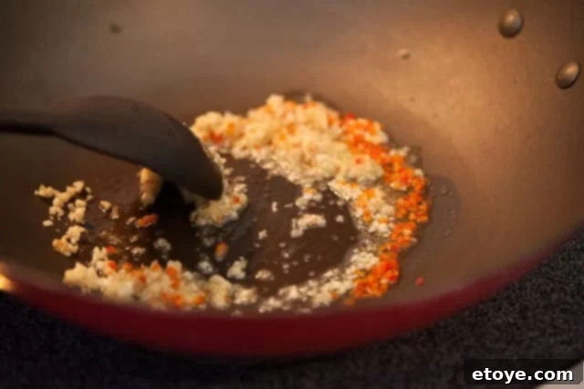 Chinese Broccoli Garlicky Ginger Miso Sauce Recipe stirring aromatics for chinese broccoli recipe