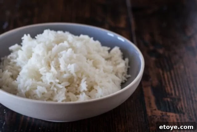 Fluffy, perfectly cooked white rice from the microwave, ready to be served