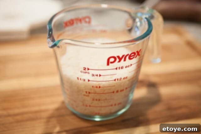 Measure raw rice precisely for microwave cooking, ensuring the correct quantity