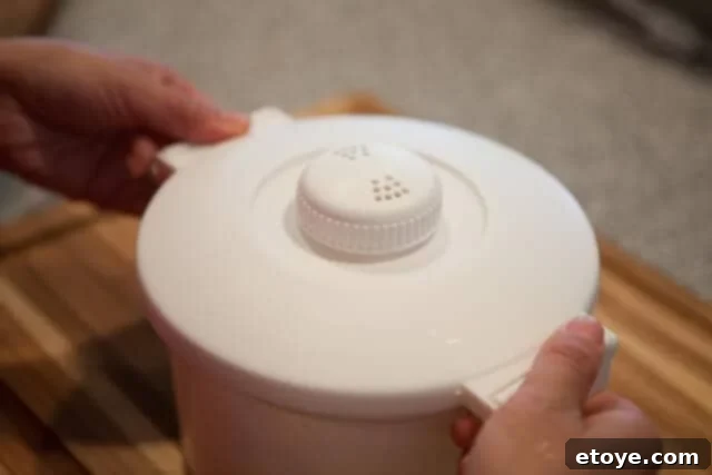 Covering the pot for microwave rice cooking, ensuring a proper seal with venting