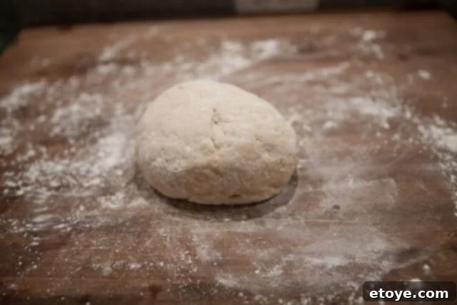 Flouring Work Surface and Dough Sprinkling Flour on Dough - Dough on a floured surface
