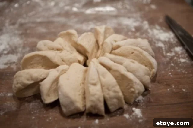 Portioning Dough for Individual Buns Dough Divided into 16 Pieces - Dough further divided into smaller, equal portions