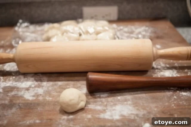 Rolling Gua Bao Dough into Ovals Rolling Dough with Muddler - Dough being rolled into an oval shape using a muddler