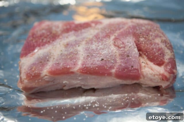 Expertly Seasoned Pork Belly Seasoned Pork Belly for Buns - A slab of pork belly sprinkled with salt and pepper