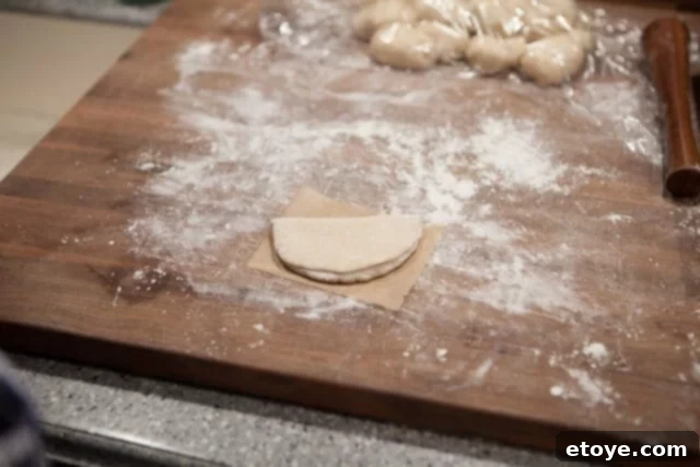Placing Buns on Parchment for Steaming Dough on Parchment Paper - Shaped bun placed on a parchment square