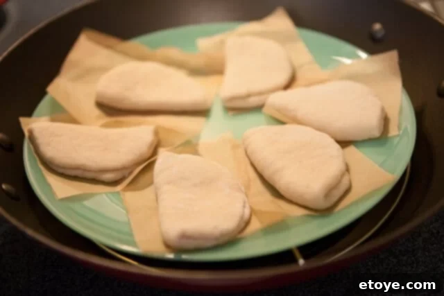 Arranging Buns for Steaming Buns on Plate for Steaming - Shaped buns arranged on a plate in the steamer
