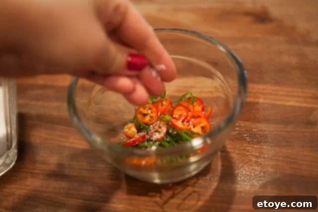Ingredients for Zesty Chili Green Onion Topping Green Onions and Chilies for Topping - Minced green onions and chilies in a bowl