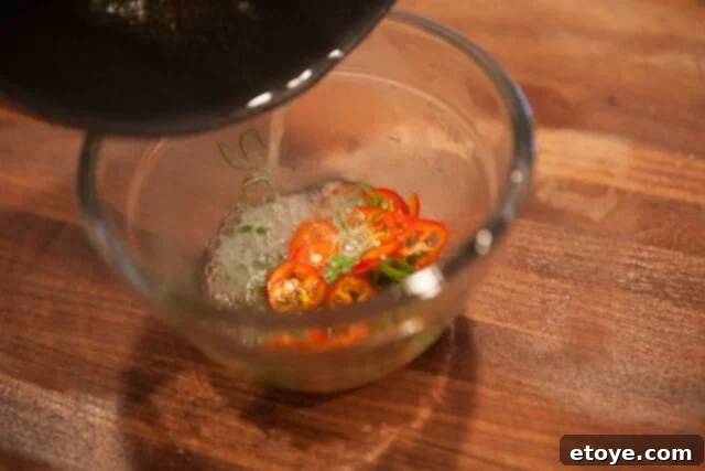 Infusing Chili Topping with Aromatic Hot Oil Chili Green Onion Sizzle - Hot oil reacting with green onions and chilies