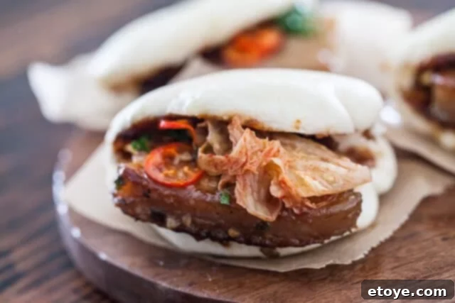 Detailed View of a Flavorful Pork Belly Bun Pork Belly Buns Detail - Close-up shot of a prepared pork belly bun