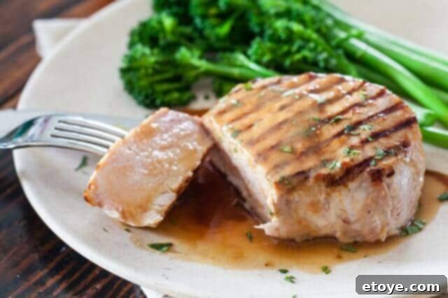 Serving of Whiskey Miso Pork Chops, beautifully plated and ready to eat, garnished with fresh parsley
