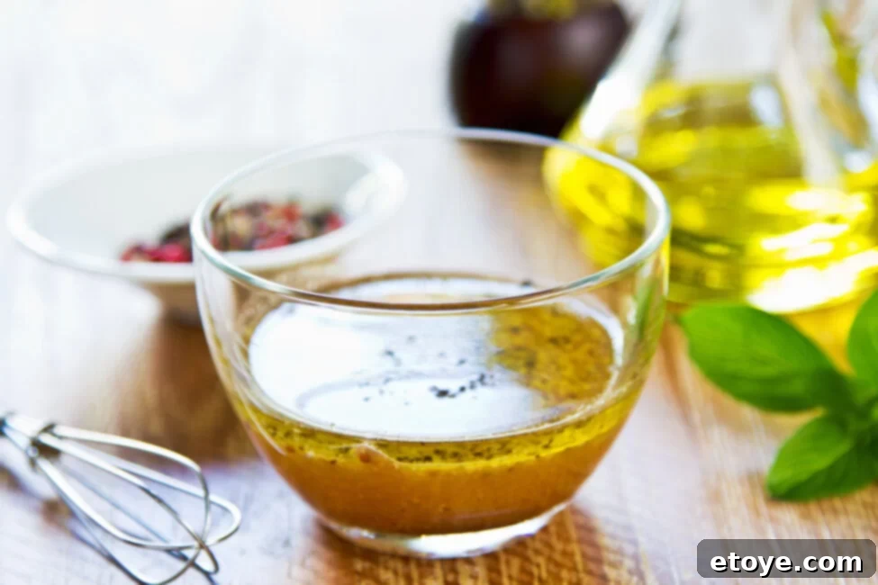 Homemade Zesty Greek Dressing 3 Greek Dressing Recipe with whisk and glass bowl