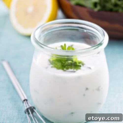 Tarragon Yogurt Dressing 5 Tarragon Yogurt Dressing in glass jar with whisk, a delicious homemade dressing for any salad