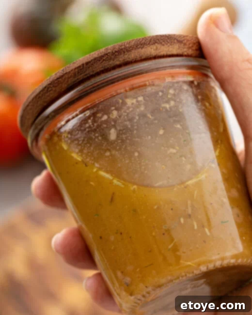 Bold Smoky Sofrito Dressing 3 Smoky Sofrito Vinaigrette in mason jar and wooden lid in hand