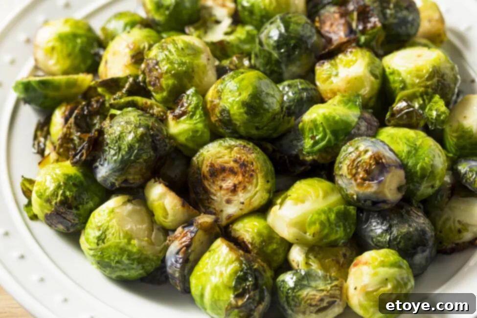 Crispy Sauteed Brussels Sprouts 4 Close up shot of sauteed brussels sprouts with chili paste and sesame seeds.